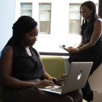 shallow focus photo of woman using MacBook